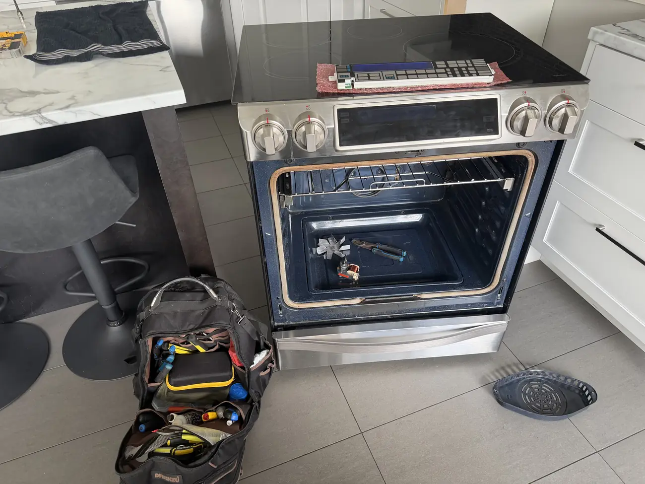 Samsung oven open showing convection fan and element during repair