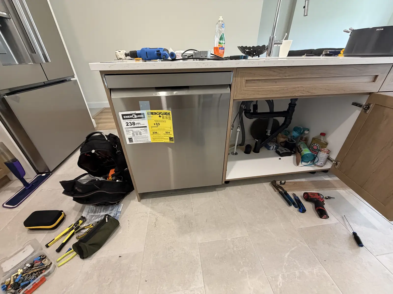 Dishwasher installation in progress with tools in Ottawa