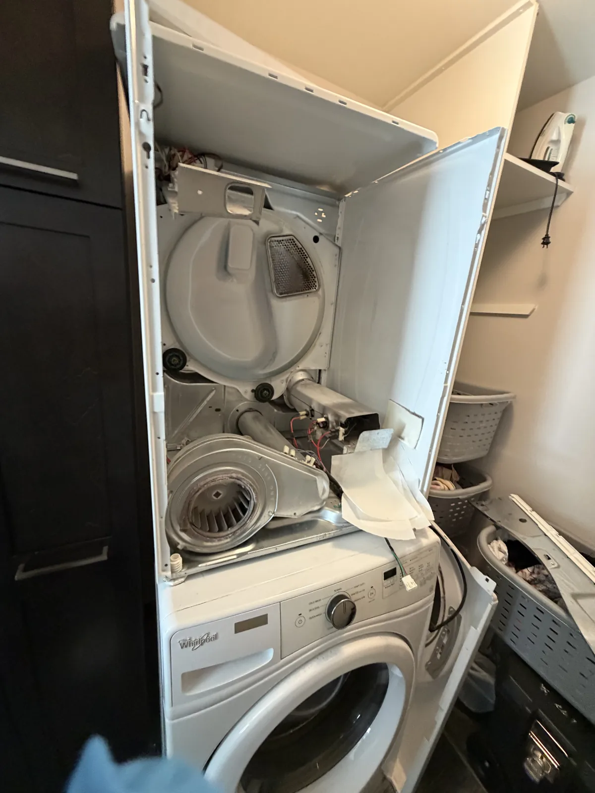 Dryer opened for internal repair in an Ottawa laundry closet