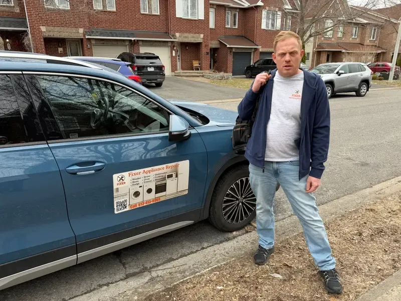 Fixer technician with branded service vehicle near Kanata