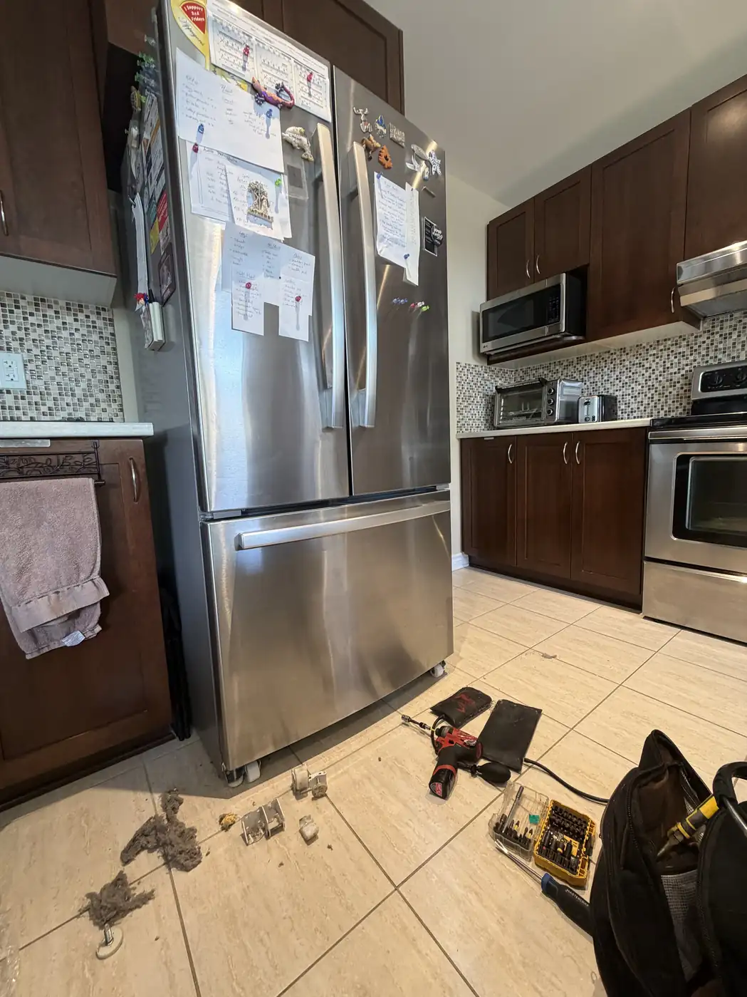 Fridge repair diagnosis with tools in an Ottawa home