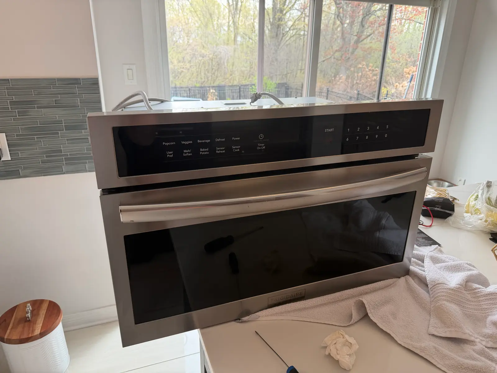 Frigidaire built-in microwave pulled out for repair in an Ottawa kitchen