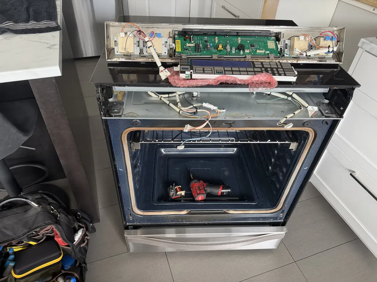 Oven control board removed during repair in an Ottawa kitchen