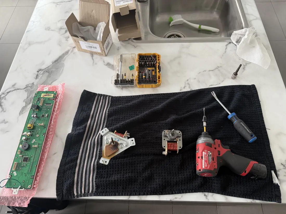 Stove control board and components laid out during repair in Ottawa